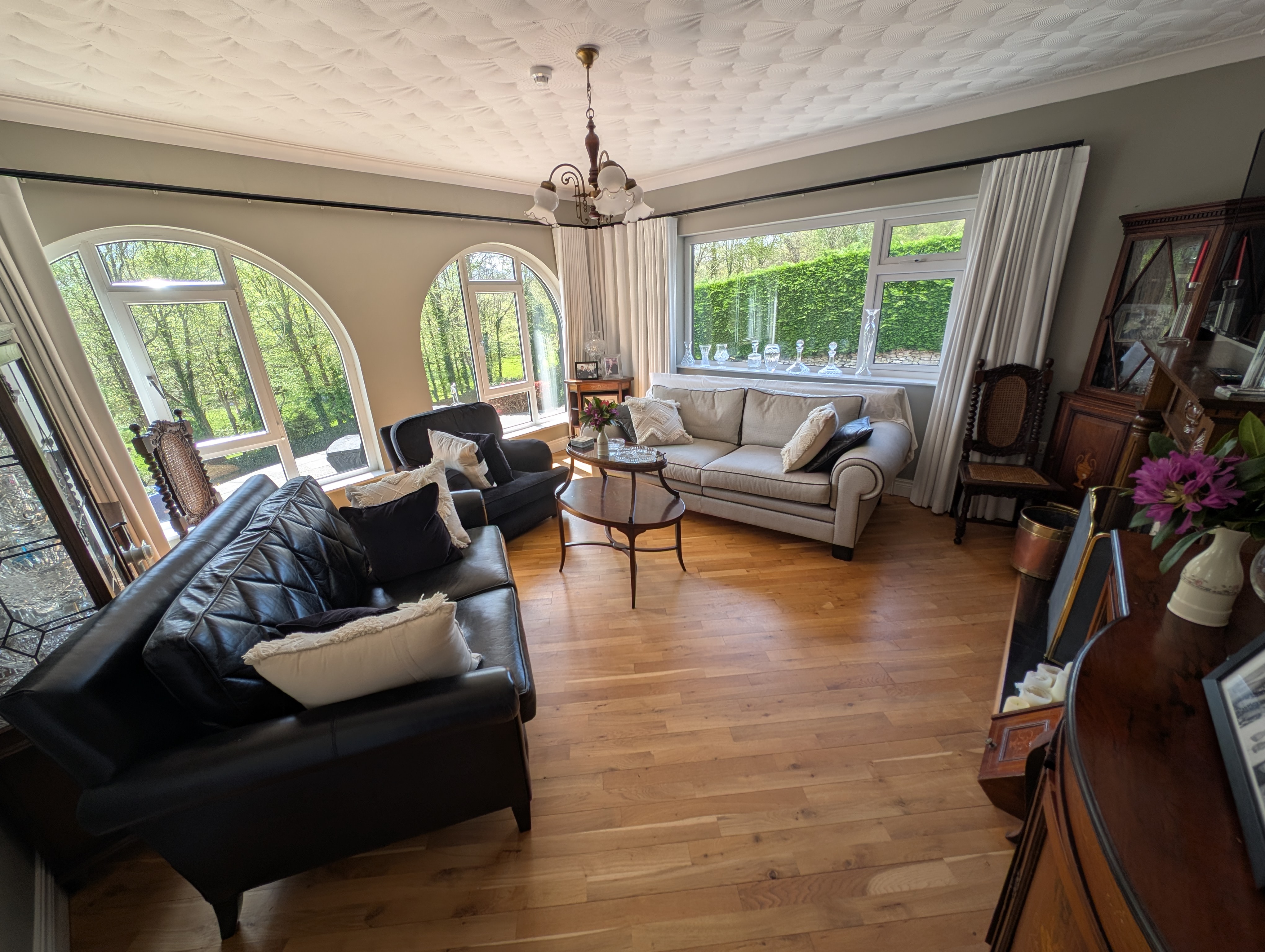 Rockcrest House guest lounge with arched windows and hardwood floors